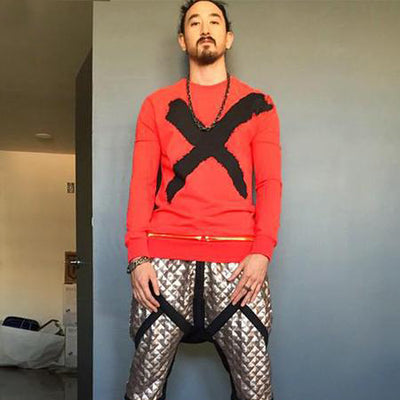 Steve Aoki wearing X BLACK red sweatshirt